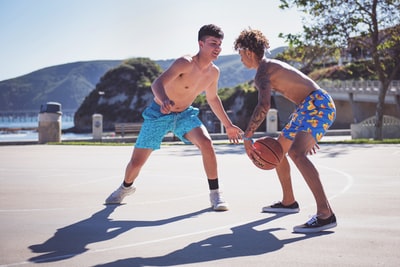 两个赤裸上身的男人打篮球白天
